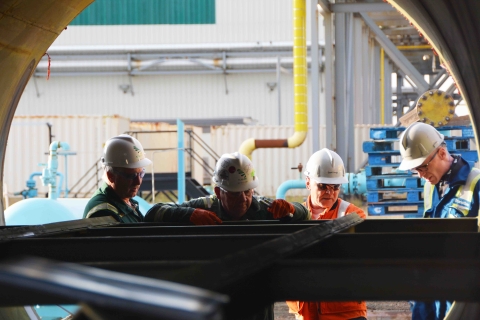 TransGas Employees inspect pipe